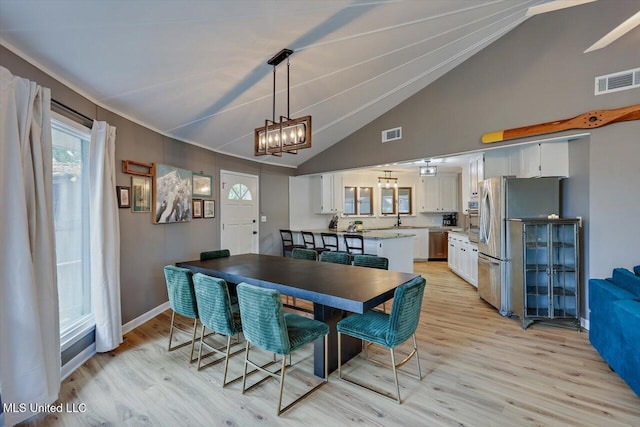 363 Lake Harbor Rd, Brandon, MS 39047 - dining area with light wood-style flooring, high vaulted ceiling, and baseboards