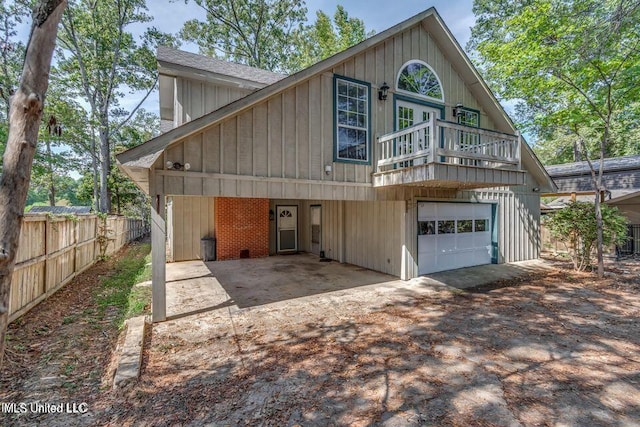 363 Lake Harbor Rd, Brandon, MS 39047 - view of front of house featuring dirt driveway, a balcony, roof with shingles, board and batten siding, and a garage