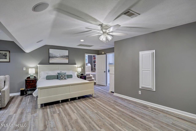363 Lake Harbor Rd, Brandon, MS 39047 - bedroom with light wood-style floors, baseboards, a textured ceiling, vaulted ceiling, and a ceiling fan