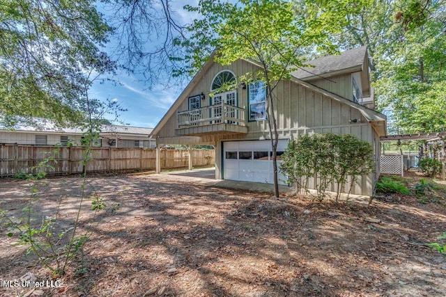 363 Lake Harbor Rd, Brandon, MS 39047 - rear view of property with a garage, driveway, a balcony, and a shingled roof