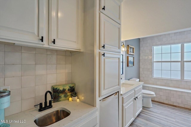363 Lake Harbor Rd, Brandon, MS 39047 - full bathroom featuring toilet, vanity, decorative backsplash, tiled bath, and wood finished floors