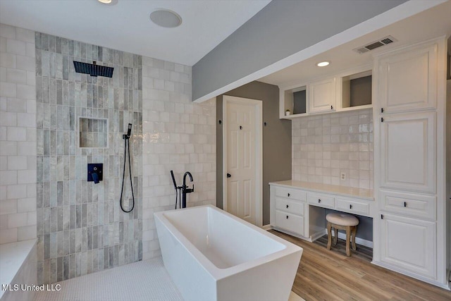 363 Lake Harbor Rd, Brandon, MS 39047 - full bathroom featuring a freestanding tub, a walk in shower, wood finished floors, backsplash, and recessed lighting