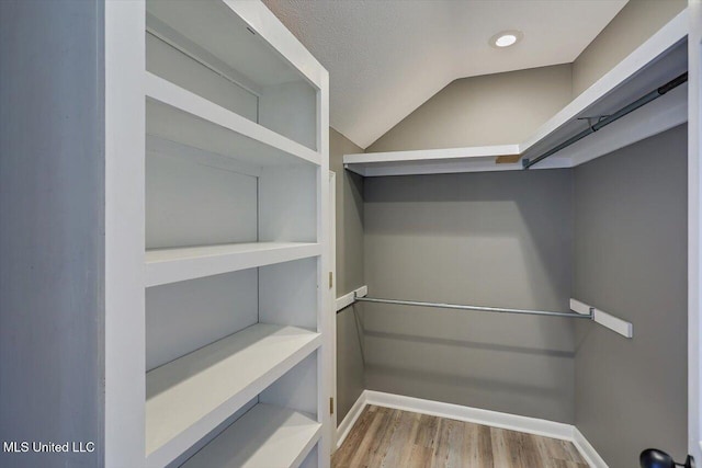 363 Lake Harbor Rd, Brandon, MS 39047 - walk in closet featuring wood finished floors and lofted ceiling