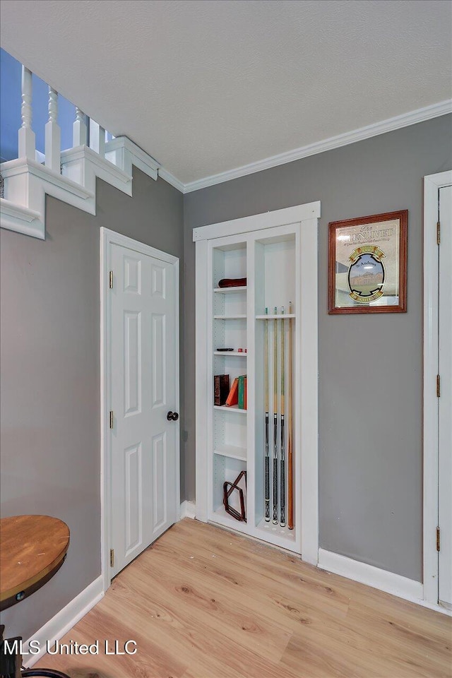 363 Lake Harbor Rd, Brandon, MS 39047 - hallway featuring wood finished floors, ornamental molding, baseboards, and built in shelves