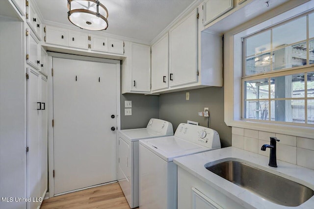 363 Lake Harbor Rd, Brandon, MS 39047 - laundry area with washer and dryer, cabinet space, and light wood-style floors