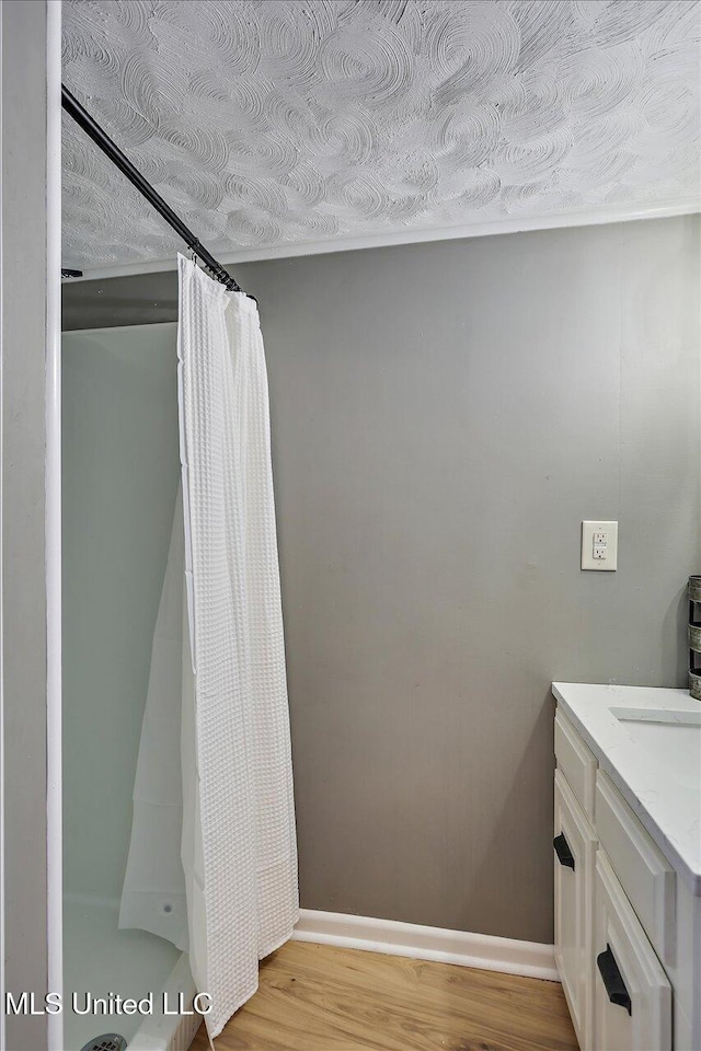 363 Lake Harbor Rd, Brandon, MS 39047 - full bath featuring wood finished floors, vanity, a shower with curtain, and baseboards