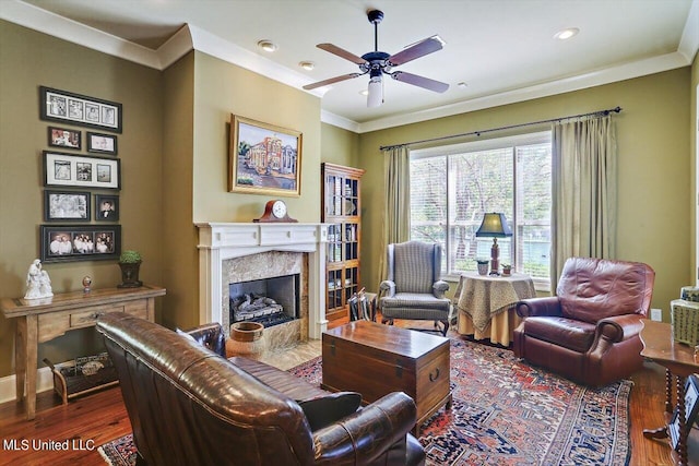 living room featuring ornamental molding, a high end fireplace, and dark hardwood / wood-style flooring