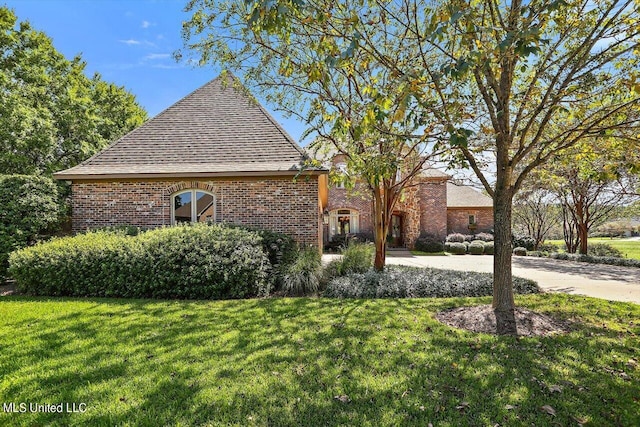 view of side of home featuring a lawn