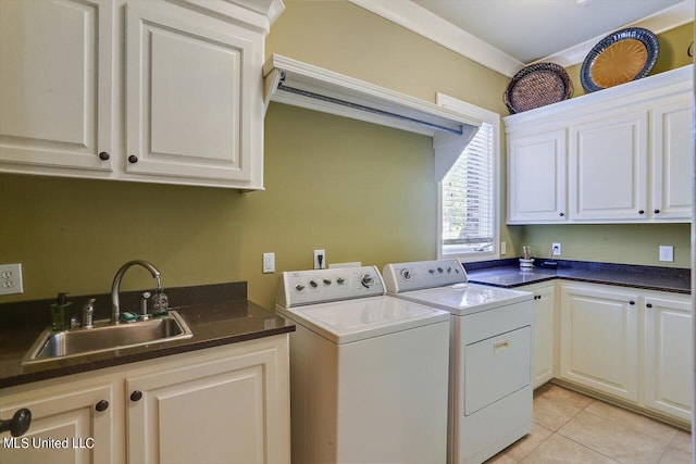 laundry room featuring cabinets, sink, separate washer and dryer, and light tile patterned floors