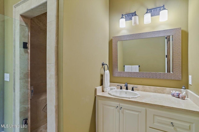 bathroom featuring vanity and tiled shower