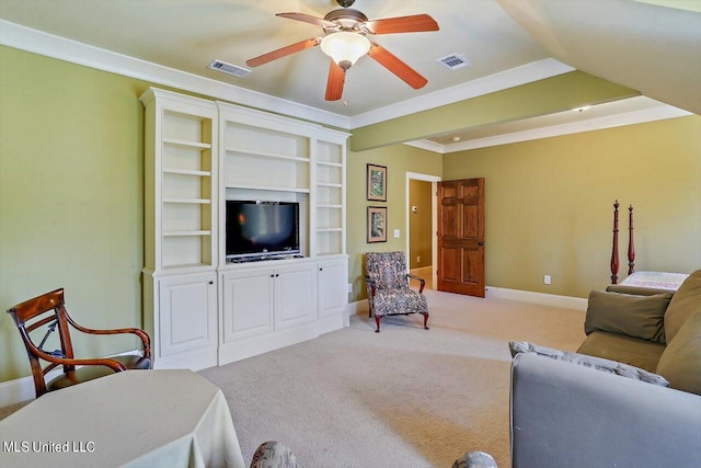 carpeted living room featuring crown molding and ceiling fan