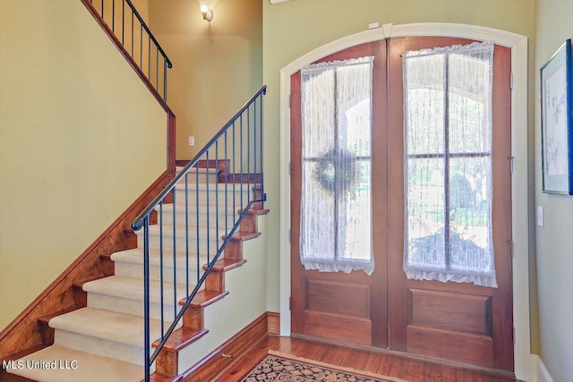 foyer entrance featuring french doors and hardwood / wood-style floors