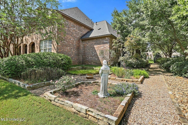 view of side of home with a lawn