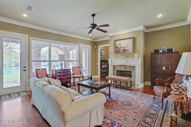 living room featuring ornamental molding, dark hardwood / wood-style floors, and ceiling fan