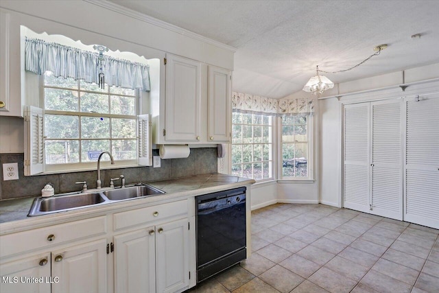 kitchen featuring white cabinets, sink, hanging light fixtures, black dishwasher, and tasteful backsplash