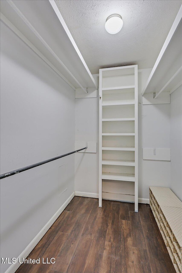 walk in closet featuring dark hardwood / wood-style flooring