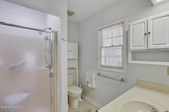 bathroom featuring tile patterned flooring, vanity, toilet, and a shower with door