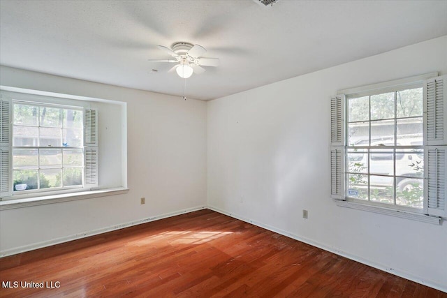 unfurnished room with ceiling fan and wood-type flooring