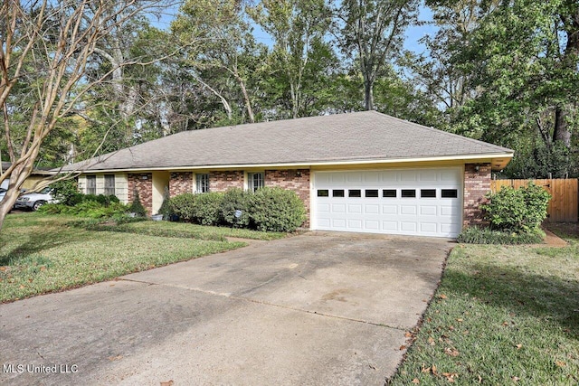 ranch-style home featuring a garage and a front lawn