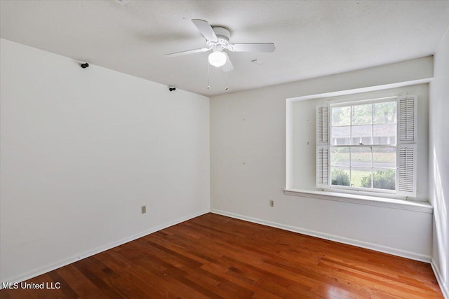 empty room featuring ceiling fan, hardwood / wood-style floors, and a textured ceiling