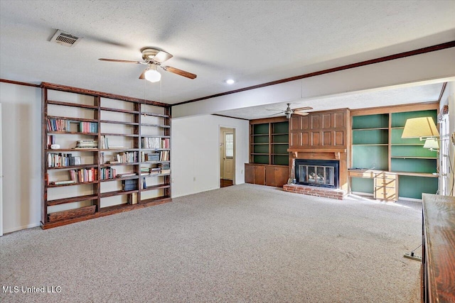 unfurnished living room featuring carpet floors, a textured ceiling, and a brick fireplace