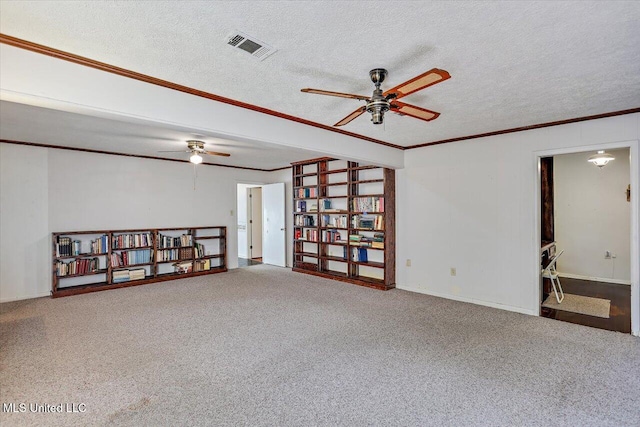 carpeted spare room featuring a textured ceiling and ornamental molding