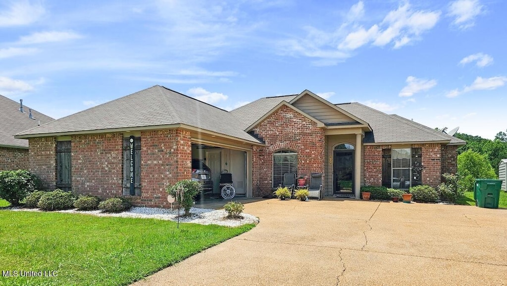 608 Carson Dr, Byram, MS 39272 - view of front of property featuring driveway, a garage, brick siding, and a front yard
