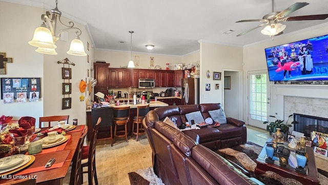 608 Carson Dr, Byram, MS 39272 - living room featuring ceiling fan, crown molding, and a tile fireplace