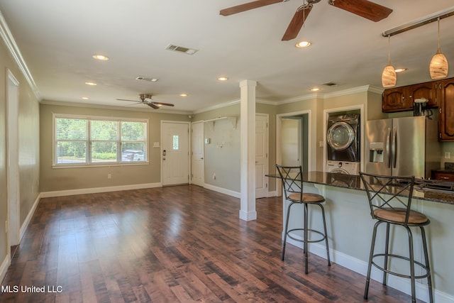 2623 Demaret Dr, Gulfport, MS 39507 - kitchen with a ceiling fan, stainless steel fridge, stacked washer / drying machine, a breakfast bar area, and crown molding