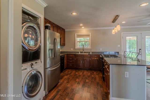 2623 Demaret Dr, Gulfport, MS 39507 - kitchen with stainless steel refrigerator with ice dispenser, stacked washer / drying machine, crown molding, dark wood-style floors, and dark stone countertops