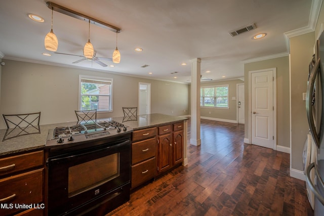 2623 Demaret Dr, Gulfport, MS 39507 - kitchen with black gas stove, ceiling fan, freestanding refrigerator, ornamental molding, and recessed lighting