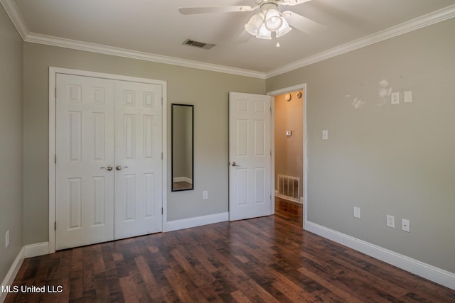 2623 Demaret Dr, Gulfport, MS 39507 - unfurnished bedroom featuring a closet, dark wood finished floors, crown molding, baseboards, and a ceiling fan
