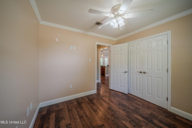 2623 Demaret Dr, Gulfport, MS 39507 - unfurnished bedroom with crown molding, baseboards, dark wood-style flooring, a closet, and ceiling fan