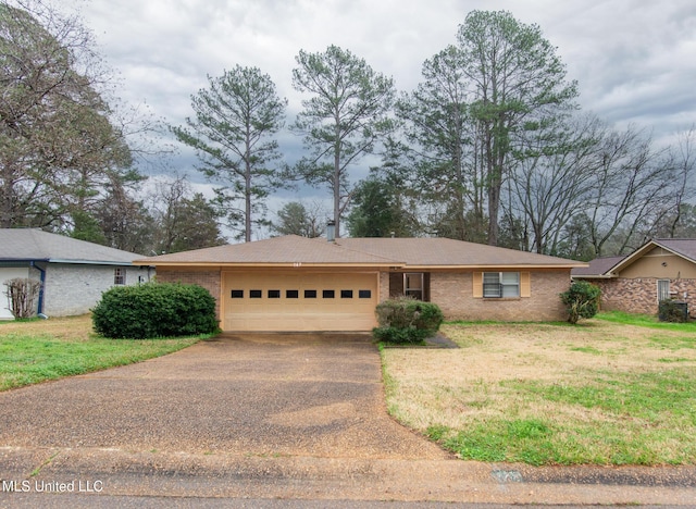 ranch-style home with a garage and a front yard