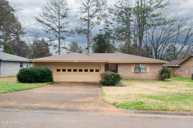 ranch-style house featuring a garage and a front lawn