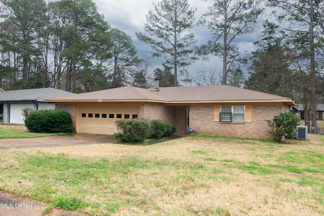 single story home featuring a garage, central AC unit, and a front yard