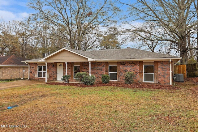 ranch-style home with central AC unit and a front lawn