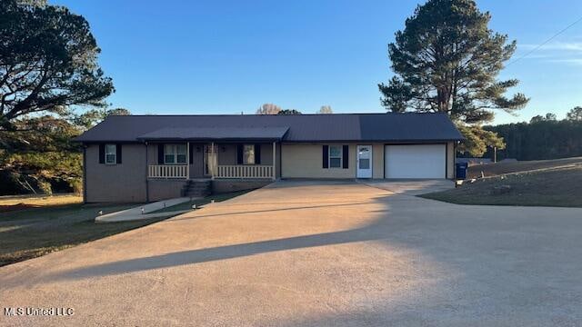 view of front of house with covered porch and a garage