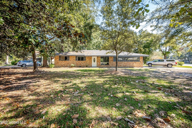 ranch-style home with a front lawn