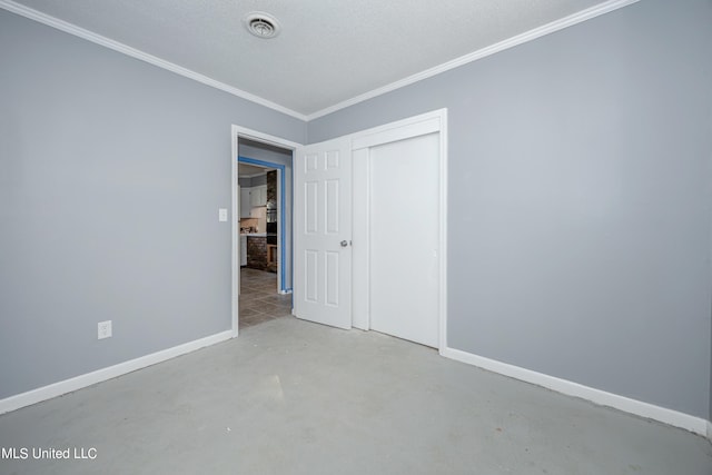 unfurnished bedroom featuring a textured ceiling, crown molding, and a closet