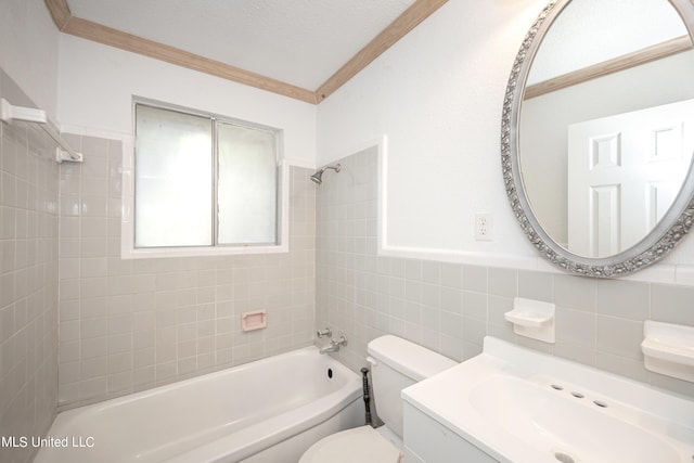 full bathroom featuring ornamental molding, a textured ceiling, toilet, tile walls, and tiled shower / bath combo