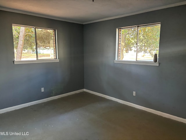 empty room with concrete flooring and ornamental molding