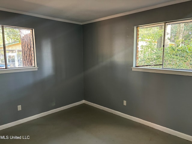 empty room with concrete flooring and crown molding