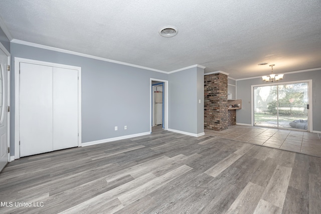 unfurnished living room with wood-type flooring, crown molding, and a textured ceiling