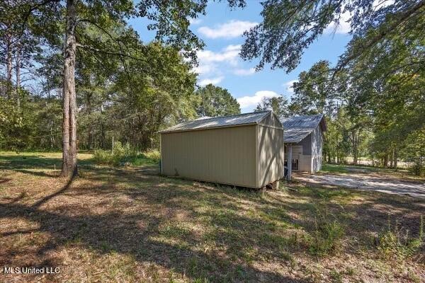 view of side of property with a storage unit