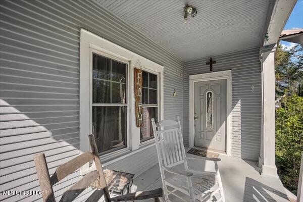 view of exterior entry featuring a porch