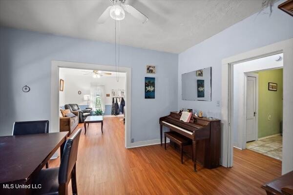 dining room featuring wood-type flooring and ceiling fan