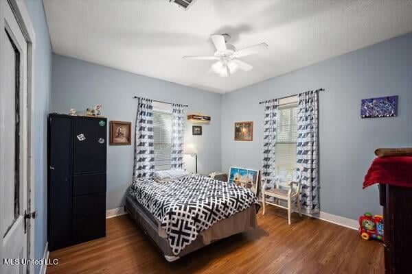 bedroom with dark wood-type flooring and ceiling fan