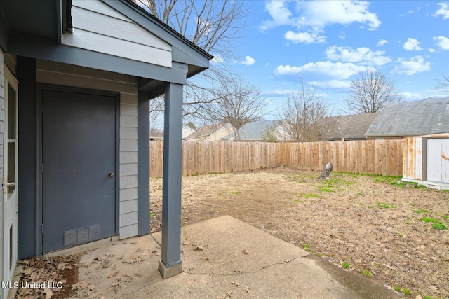 view of yard with a fenced backyard and an outbuilding