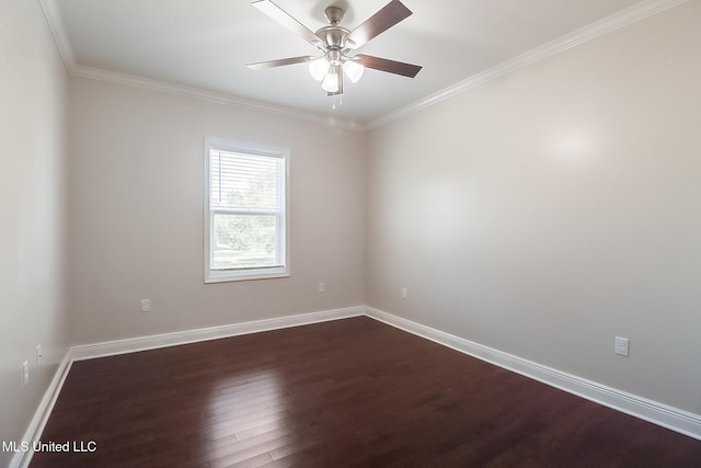 spare room featuring dark wood-type flooring, crown molding, baseboards, and a ceiling fan